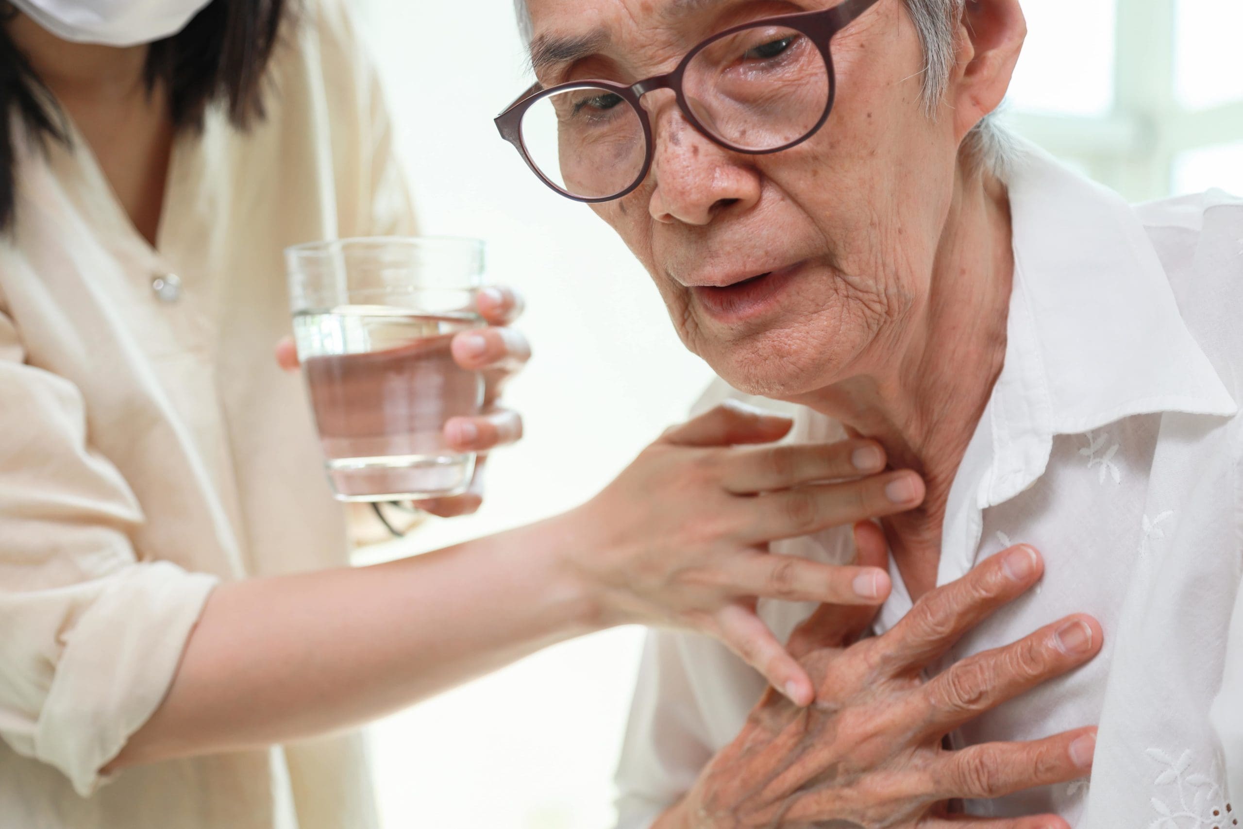 Image of a carer assisting a person with dysphagia
